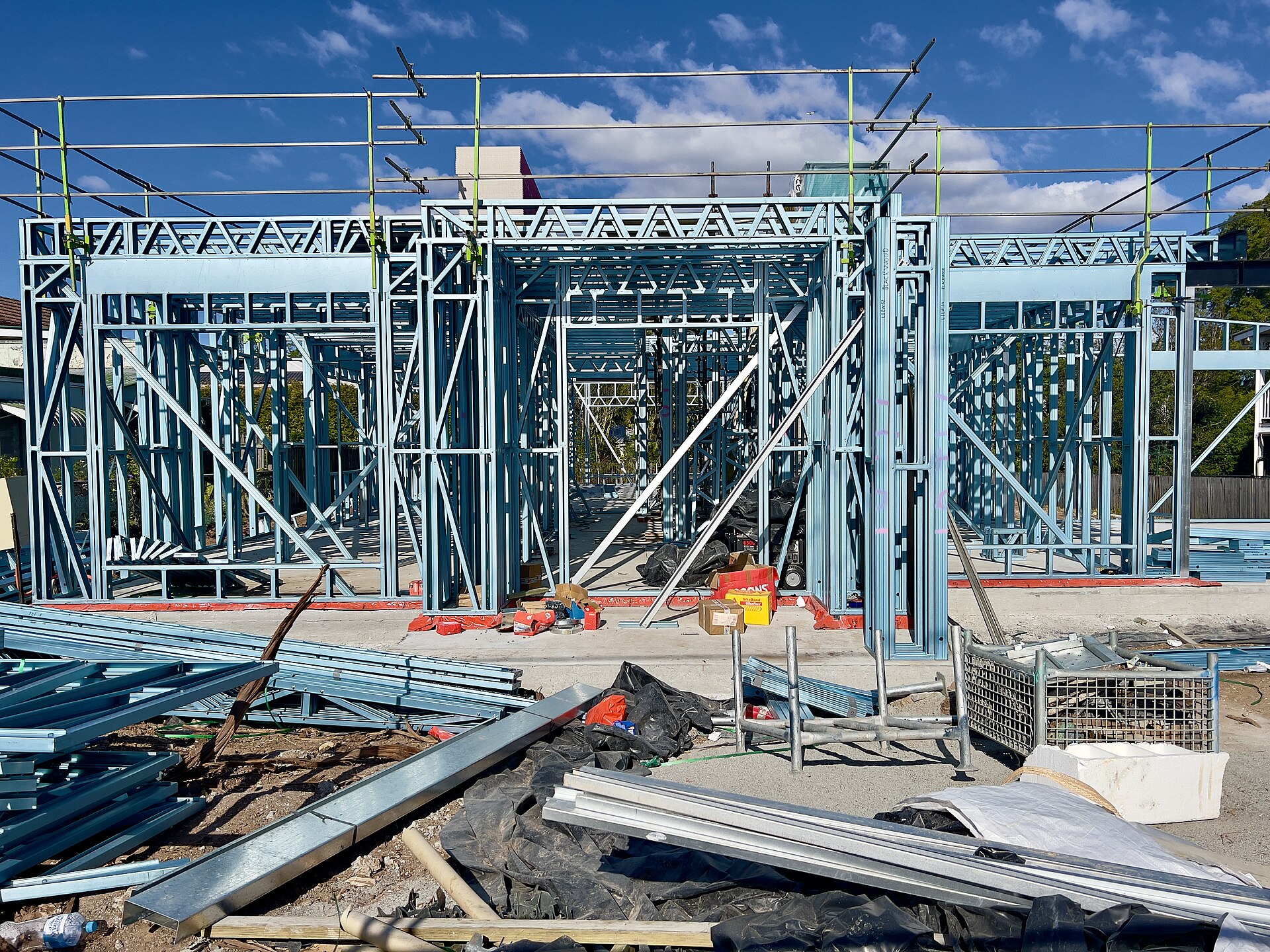 A house frame under construction in Sherwood, the sort of site an owner-builder must actually run.
